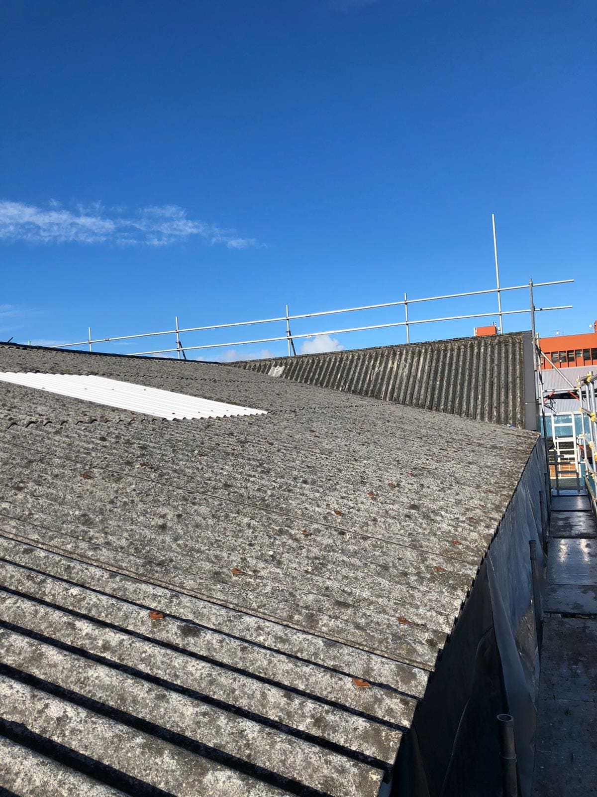 Weathered asbestos roof on a commercial building