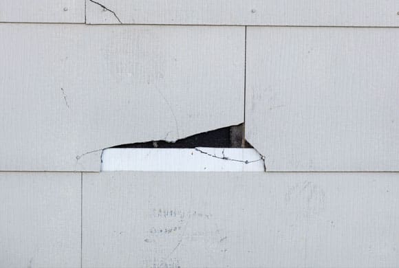 Cracked asbestos cement cladding on a house