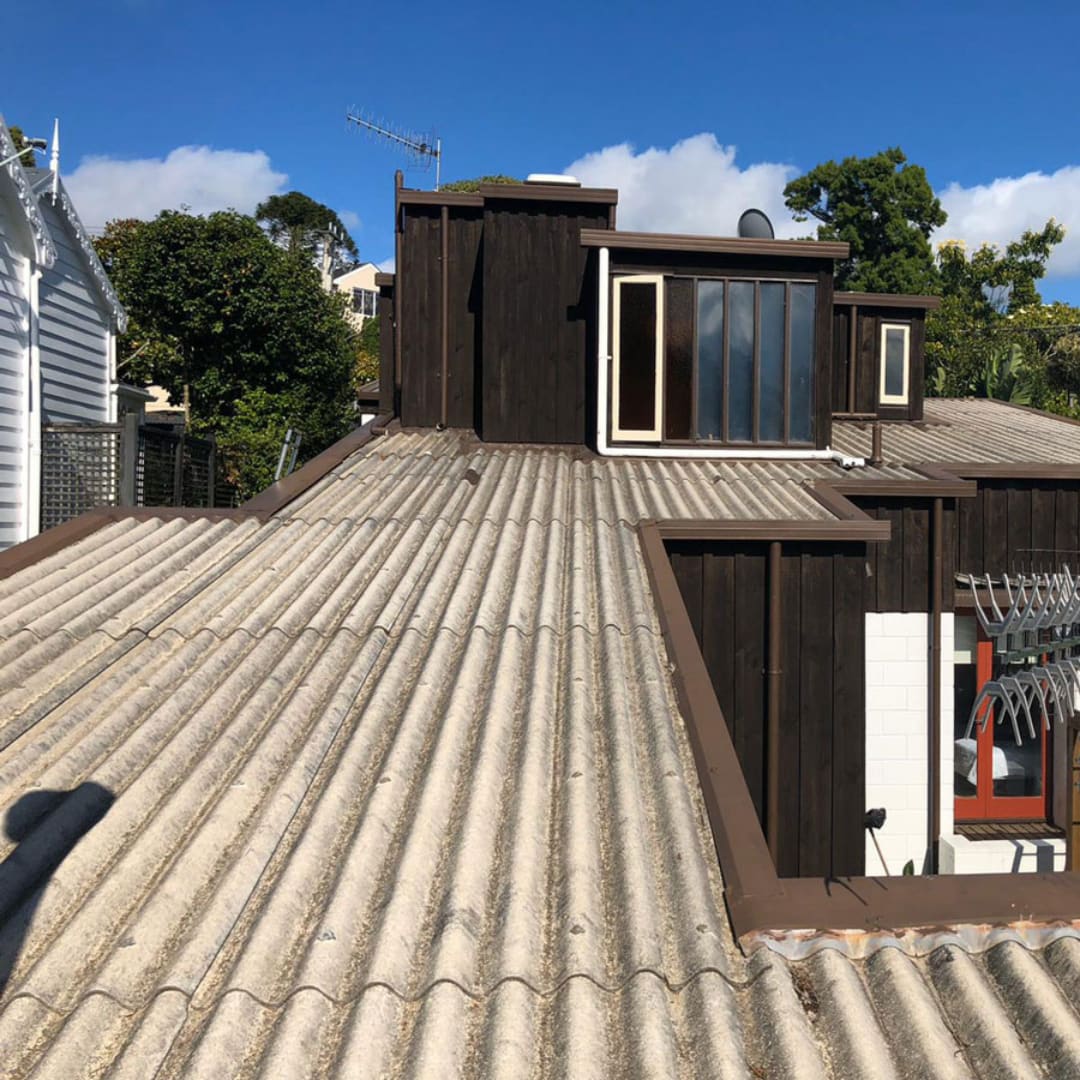 Weathered Super Six asbestos cement roofing on a home